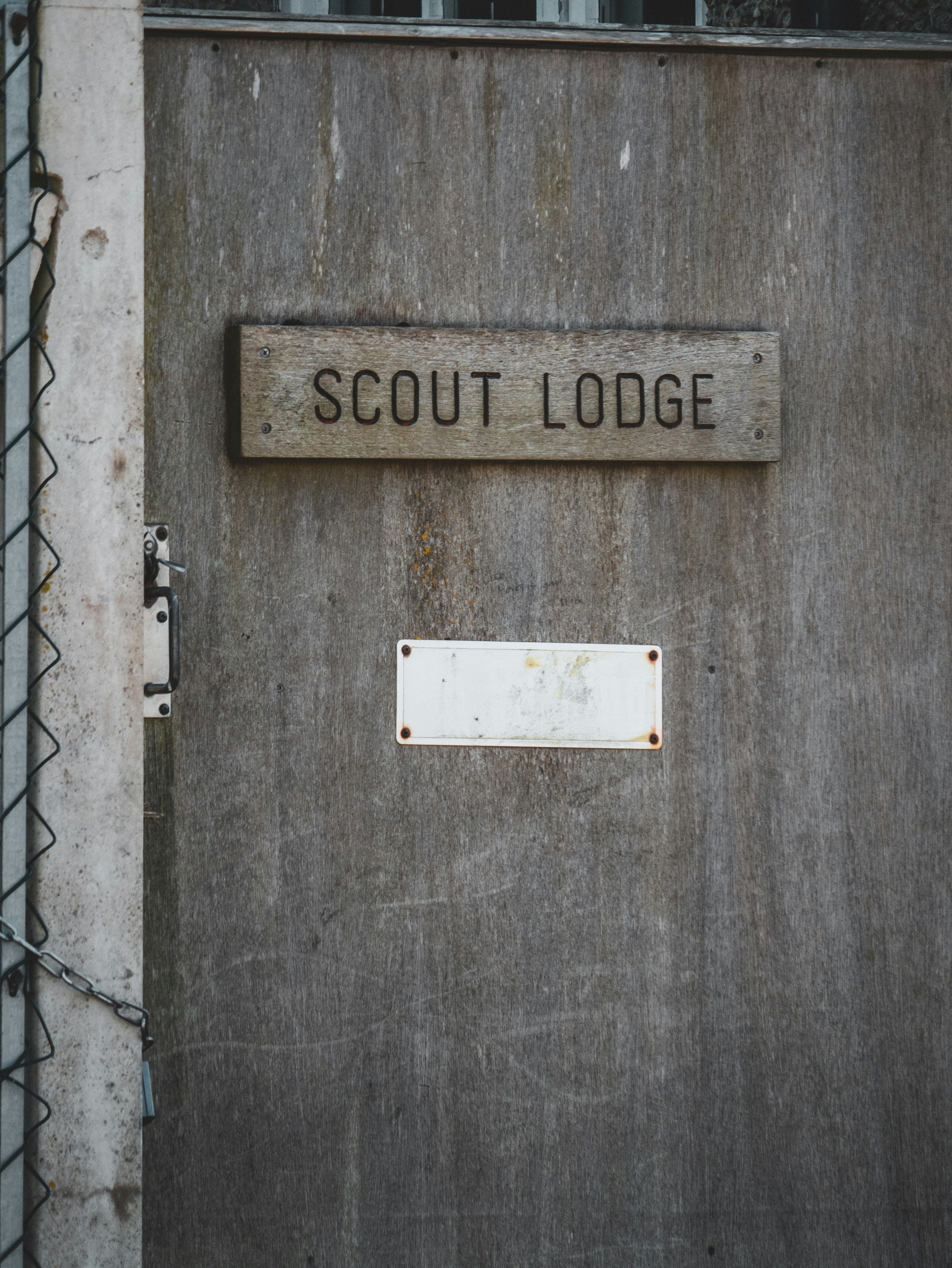 brown wooden door with white and red no smoking sign